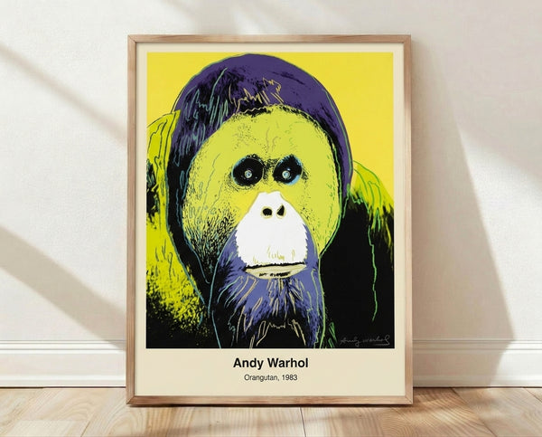 Bold pop art poster featuring a vibrant orangutan portrait in bright pink, cyan, and chartreuse on black, celebrating wildlife in Warhol's iconic style.