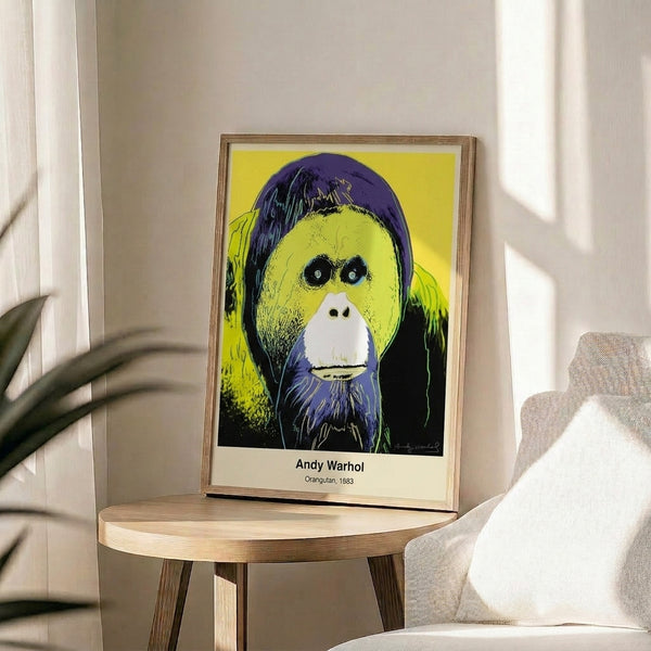 Vibrant framed poster of an endangered orangutan rendered in pop art style with glowing neon colors and dramatic black contrast.