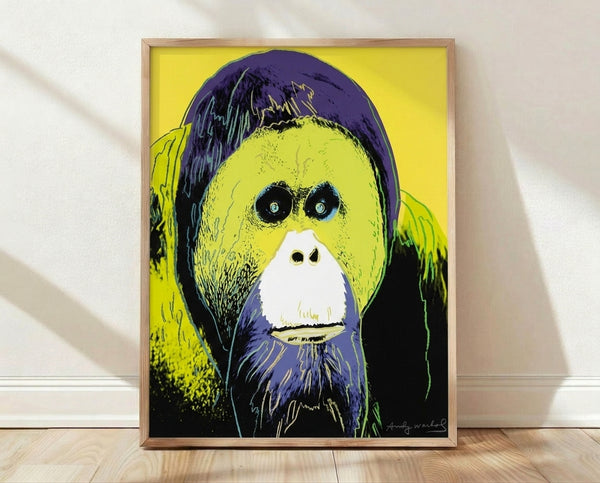 Pop art style orangutan portrait in vibrant jewel tones of emerald, sapphire, and coral, displayed as a framed poster on a wall.