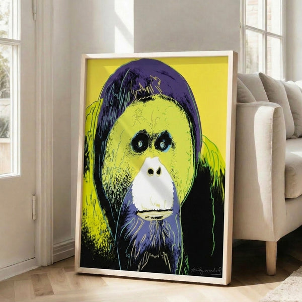 Stylized orangutan face rendered in vivid pop art colors including electric blue, hot pink, and golden yellow as a framed wall print.