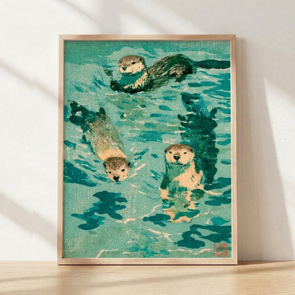 Framed Japanese woodblock print depicting three otters among seaweed and fish in a peaceful naturalistic scene, rendered in teal, cream, dark green, and sage tones with minimalist vintage aesthetics.