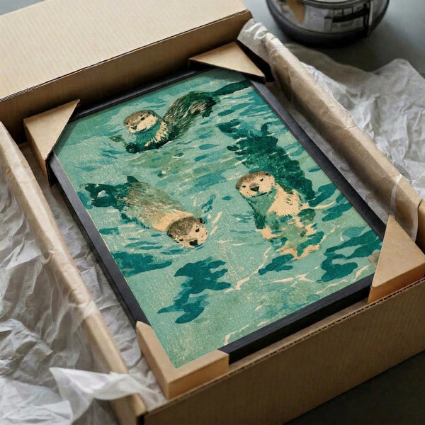 Japanese woodblock framed poster with three otters swimming among fish and aquatic flora, capturing a zen mood through minimalist design and a peaceful palette of teal, sage, and cream.