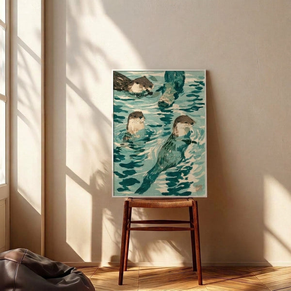 Serene Japanese woodblock poster showing naturalistic otters diving and playing in cool-toned teal waters with aquatic plants and fish, framed on a wall.
