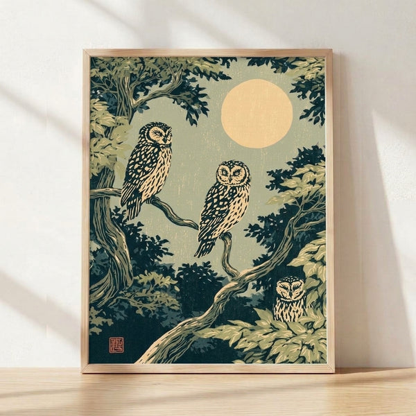Framed Japanese woodblock print of owls perched on branches beneath a luminous moon, rendered in sage green, cream, and dark teal with Art Nouveau styling and serene nocturnal mood.
