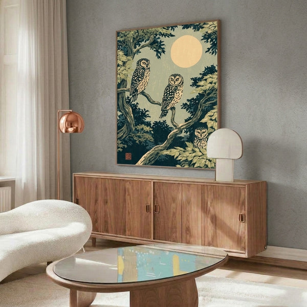 Mystical nocturnal wall art in Japanese woodblock tradition: owls nestled among tree branches with an ethereal moon, using muted sage green, teal, and cream palette creating contemplative atmosphere.