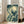 Vintage-style woodblock artwork showing owls beneath a full moon in a tree, with contemplative and mystical atmosphere in ivory and deep teal hues.