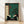 Japanese woodblock-style framed poster depicting a serene panda contemplating a chess board beside a delicate bonsai tree in a minimalist room, rendered in deep teal, cream, and forest green tones.