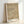 Minimalist wall art with rhythmic textural elements in cream and brown, abstract composition evoking contemplative mood through geometric arrangement.
