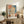 Framed modernist print with two stylized faces in burnt sienna, ochre, and slate blue creating an introspective, whimsical composition in Klee's distinctive abstract manner.