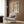 Abstract Bauhaus poster featuring two geometric figures with faceless features rendered in warm and cool earth tones, embodying early twentieth-century modernist portraiture.