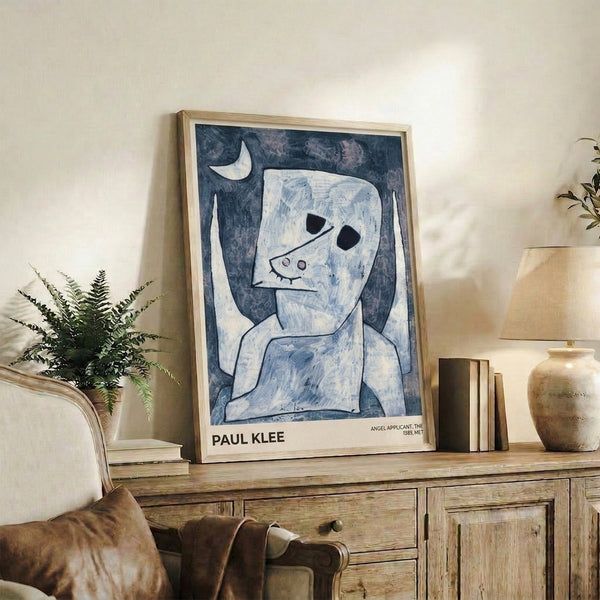 Modernist framed print of Klee's Angel Applicant with minimalist angel and moon imagery in soft grays, whites, and pale blues, evoking quiet wonder and introspection.