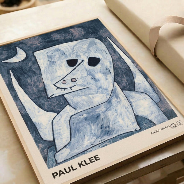 Abstract angel artwork framed on wall, Paul Klee's 1939 Angel Applicant rendered in muted tones and modernist style, balancing whimsical forms with meditative restraint.