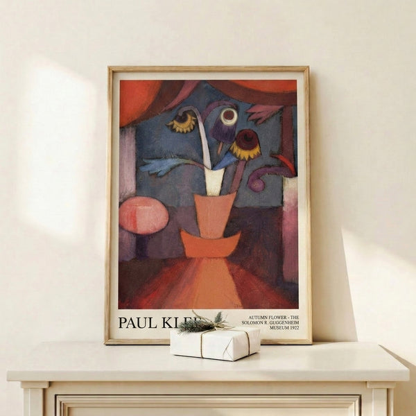 Framed modern art print combining abstract flower motifs and vessel form in slate gray, burgundy, and golden yellow with playful, whimsical character.