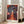 Bauhaus-style abstract composition merging botanical and facial elements in a stylized vase, rendered in rich rust orange, deep blue, and ochre warm tones.