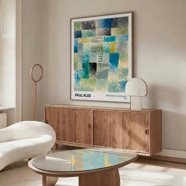 Bauhaus-inspired framed poster with meditative geometric arrangement of house-like shapes in cream, teal, and subdued yellow accents.