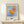 Modern art print in the Klee style showing a playful figure with contemplative mood, rendered in sky blue, burnt orange, and cream on a gallery-quality poster.