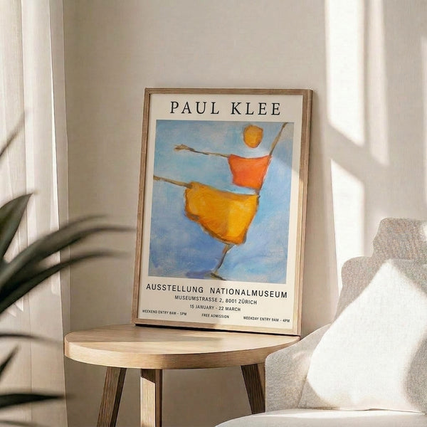 Framed modern poster displaying a whimsical Bauhaus composition of a figure and celestial forms in cream, sky blue, and golden hues with contemplative character.