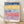 Bauhaus-style framed poster of an abstract old city with geometric buildings in navy blue, golden yellow, dusty rose, and purple tones.
