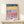 Abstract architectural wall art in modernist style showing stacked buildings rendered in navy, dusty rose, and yellow on cream background.