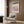Modernist wall art featuring a stylized old city composition with layered architectural shapes in a sophisticated palette of blue, rose, and gold.