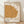 Abstract geometric portrait by Paul Klee titled One Who Understands, featuring a stylized face in ochre, tan, and burnt sienna tones on cream background, exemplifying Bauhaus minimalist design.