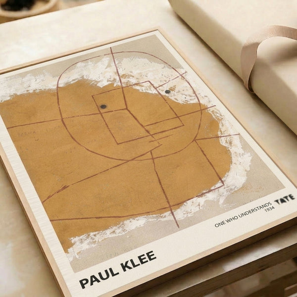 Paul Klee's One Who Understands poster: minimalist abstract portrait with geometric form in off-white, ochre, and burnt sienna, characteristic of Bauhaus art.