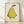 Minimalist boho framed poster of a sleepy pear character with closed eyes and a gentle expression, rendered in soft pale yellow and sage green tones with a cream background and dark green leaf details.