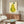 Tranquil framed wall art of a stylized pear with leaf in contemporary minimalist aesthetic, using soft cream and muted green color palette.
