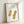 Cream and gold toned framed poster featuring two peanuts rendered as elegant line drawings with a meditative, educational quality in folk art tradition.