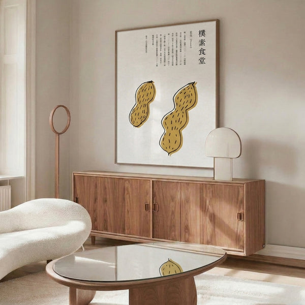 Cream-toned framed art featuring two peanuts rendered in contemplative line art style with dark brown and gold accents, reflecting folk art traditions.