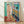 Abstract minimalist framed poster featuring soft pearly tones and organic shapes suggesting a figure near a window, in the style of paper cut artwork.