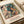 Framed Bauhaus-inspired exhibition print displaying dynamic interplay of geometric human and animal figures in cream, ochre yellow, rust red, and teal color scheme.