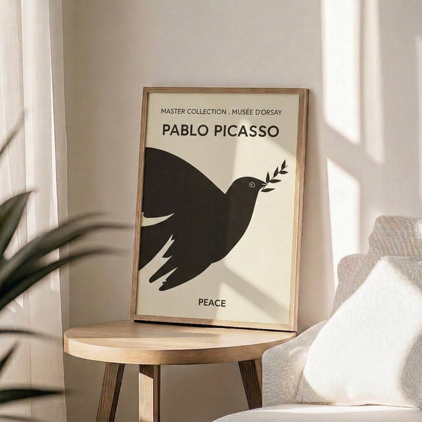 Framed line art print of Picasso's celebrated peace dove symbol rendered in bold black strokes with warm cream backdrop.