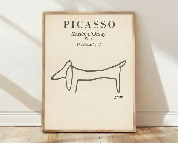 Minimalist line art portrait of a dachshund in charcoal gray and black on cream background, framed poster with whimsical elegance.