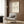 Cream-colored framed poster featuring a delicate charcoal line art dachshund, minimalist aesthetic with whimsical sophistication.