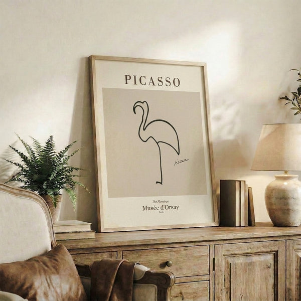 Framed minimalist flamingo artwork with flowing black linework on cream-colored background, sophisticated gallery-style poster.