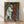 Framed poster of Cezanne's Pierrot and Harlequin, depicting two costumed figures in muted earth tones and soft blues against an abstracted background, hanging on a wall.