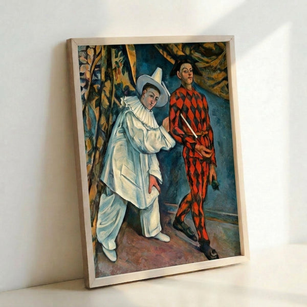 Vintage-inspired framed artwork showing two theatrical characters in Pierrot and Harlequin costumes, painted in subdued palette of cream, rust, and slate blue.