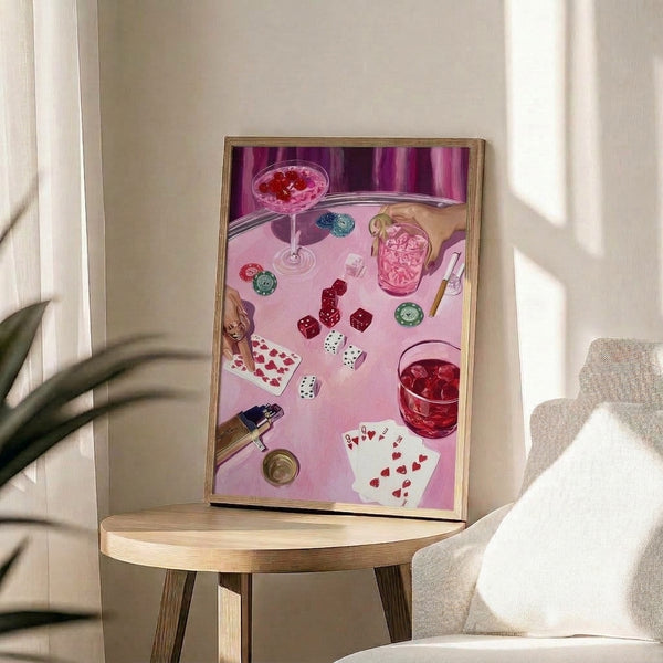 Trendy framed pop art poster with a woman's manicured hand amid glamorous casino imagery—cards, chips, champagne, and cigarette—rendered in luxe pink, burgundy, and cream tones.