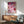 Modern playful poster art blending coquette aesthetics with casino charm: cards, dice, cocktail, and accessories in sophisticated pinks and golds against deep purple accents.
