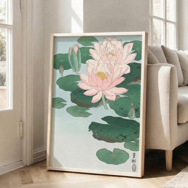 Serene botanical woodblock print of a blooming lotus with soft pink flowers and layered green leaves in minimalist style, displayed as framed art.