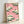 Whimsical framed art print in Japanese woodblock tradition showing a bird perched near pine foliage against a soft pink sky with cloud formations.