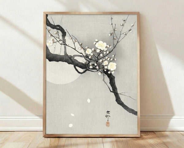 Serene Japanese woodblock print featuring delicate plum blossoms on a branch beneath a pale moon, rendered in soft cream, charcoal, and grey tones in a minimalist style.