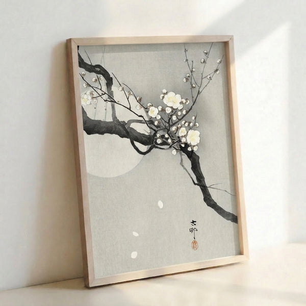 Meditative Japanese woodblock artwork showing delicate blossoms in cream and black against a soft yellow moon, evoking quiet contemplation and natural beauty.