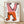 Bold Bauhaus exhibition poster featuring abstract pink and orange geometric figures with outstretched hands against black and cream, playful avant-garde design framed on wall.