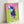 Modern pop art poster displaying an equestrian polo subject in striking pink tones set against vivid green, gallery-framed on wall.