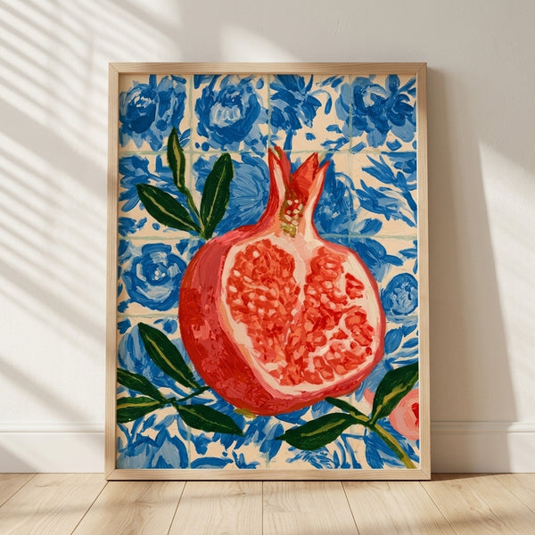 Vibrant watercolor pomegranate with crimson fruit and deep green leaves on a rich cobalt blue tile background, framed as a boho botanical art print.