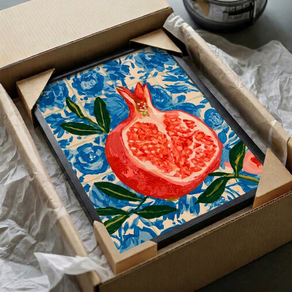 Decorative watercolor artwork depicting a pomegranate fruit with flowing botanical elements in warm reds and soft pinks, set against a vibrant blue tile design.