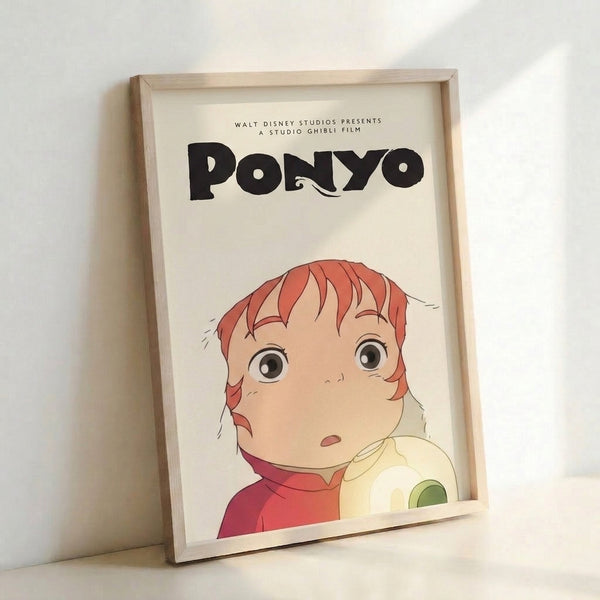 Framed Studio Ghibli poster depicting Ponyo in a whimsical moment, blending soft peach and coral accents with moss green details in a gentle, storybook-like composition.