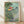 Whimsical Studio Ghibli-inspired poster featuring a girl and boy on a small boat surrounded by a magical fish character and lush forest scenery in soft forest green, seafoam blue, and coral tones.